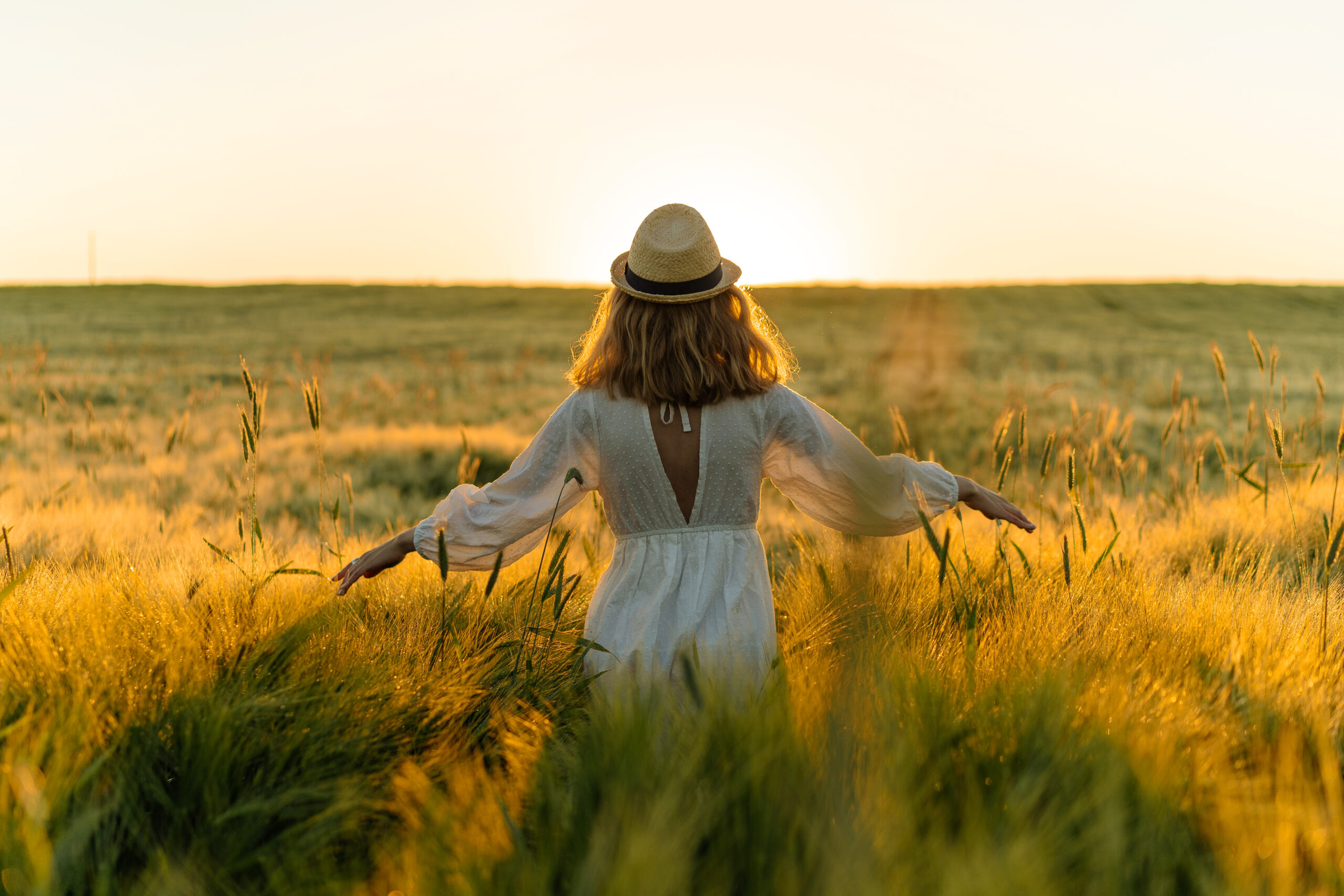 young beautiful woman with blond long hair in a white dress in a